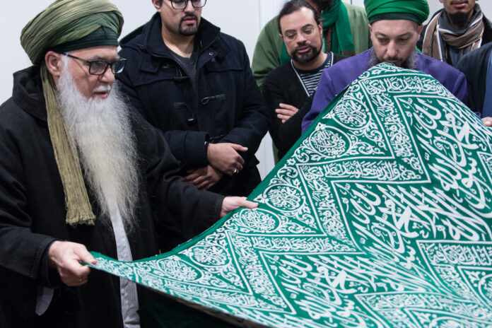 Mawlana Shaykh Muhammad Hisham Kabbani with Ghilaf of Rawdat an-Nabi (s).jpg